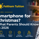 Parent and child talking at the kitchen table with a mobile phone between them